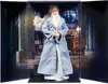 A doll of Albus Dumbledore in a display case with a backdrop of a library or study. Podgląd zdjęcia produktu