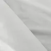 A close-up view of folded white fabric, likely bedding. Produktbild-Vorschau