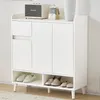 A white shoe cabinet with a drawer and three doors, standing on wooden legs. Produktbild-Vorschau
