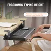 A person's hands are resting on the armrests of a chair, with a desk and an under-desk keyboard tray in the foreground. Produktbild-Vorschau
