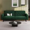 A green sofa with a decorative pillow is shown in a living room setting. Produktbild-Vorschau