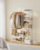 A white metal garment rack with shelves, filled with clothing, accessories, and storage boxes, set against a light-colored wall and floor. Produktbild-Vorschau