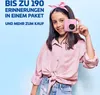 A young girl is holding a pink instant camera in front of her face, smiling. The background is a light blue gradient. Anteprima dell’immagine prodotto