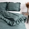 A close-up shot of a bed with green bedding. Produktbild-Vorschau
