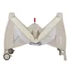 A baby travel cot is shown from a slightly elevated front-facing angle, with its sides partially open. Produktbild-Vorschau