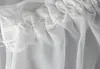 A close-up view of the top edge of a white sheer curtain, showing the header with gathering and stitching. Produktbild-Vorschau