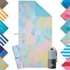 A collage of beach towels, with a main towel in the center and smaller swatches of other towel designs arranged around it. Podgląd zdjęcia produktu