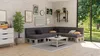 A modern living room with a sectional sofa made of pallet cushions, a coffee table, and a large window overlooking a garden. Náhled obrázku produktu