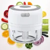 A white electric mini chopper surrounded by various chopped and whole fruits and vegetables. Náhľad obrázku produktu