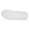 The sole of a white shoe is shown from an underneath view against a white background. Podgląd zdjęcia produktu