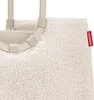 Close-up of a fluffy cream-colored bag with beige handles and a red brand tag. Náhľad obrázku produktu
