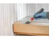 A person is applying a finish to a wooden surface with a brush. Produktbild-Vorschau