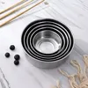 A set of nested stainless steel bowls on a marble-like surface, with chopsticks and blueberries. Produktbild-Vorschau