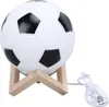 A soccer ball-shaped lamp on a wooden stand. Produktbild-Vorschau