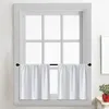 A white kitchen window with two white cafe curtains hanging on a black rod. Náhled obrázku produktu