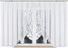 A white lace curtain with a decorative pattern in the center, hanging in front of a window. Anteprima dell’immagine prodotto