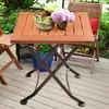 A wooden table with plants and flowers on a deck. Produktbild-Vorschau