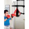 A young boy is shown punching a boxing bag attached to a door. Podgląd zdjęcia produktu