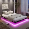 A modern bedroom with a bed, nightstand, plant, and window view. Podgląd zdjęcia produktu
