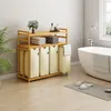 A bathroom scene with a laundry sorter and a bathtub. Anteprima dell’immagine prodotto
