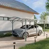 A car is parked under a carport next to a house. Produktbild-Vorschau