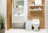 A modern bathroom with a white vanity, toilet, and a white wicker laundry basket. Náhľad obrázku produktu