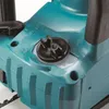 A close-up view of the top of a teal and black chainsaw, focusing on the oil cap and some indicator markings. Produktbild-Vorschau