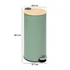 A green pedal bin with a bamboo lid and a silver pedal, shown with dimensions indicated by measurement lines and text. Produktbild-Vorschau