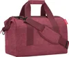 A studio shot of a maroon duffel bag. Anteprima dell’immagine prodotto