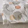 A close-up view of a patterned fabric with circles. Produktbild-Vorschau