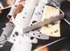 A close-up view of a collection of metal and wooden components, possibly from a watch or intricate mechanism, with the number '13' visible on one of the white pieces. Náhled obrázku produktu