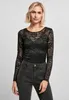 A woman is posing in front of a plain background, wearing a black lace long-sleeved top and dark wash jeans. Produktbild-Vorschau
