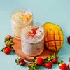 Two glasses of fruit drinks with strawberries and mangoes, surrounded by fresh fruits. Náhľad obrázku produktu