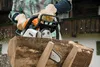 A person is using a chainsaw to cut a log. Produktbild-Vorschau