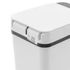 Close-up view of the top corner of a white trash can, showing a warning label. Náhled obrázku produktu