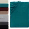 A stack of folded blankets in various colors is shown on the left, with a single teal blanket prominently displayed on the right. Produktbild-Vorschau