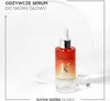 A bottle of Kérastase hair serum is displayed against a white and gray background, with a circular element behind it. Podgląd zdjęcia produktu
