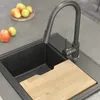 A kitchen sink with a faucet and a cutting board, along with some apples on the counter. Náhled obrázku produktu