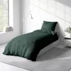 A bedroom scene with a bed dressed in green bedding. Produktbild-Vorschau