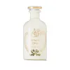 A white perfume bottle with gold and green accents on a white background. Anteprima dell’immagine prodotto
