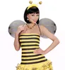 A woman wearing a bee costume, including a wig, headband with antennae, wings, and a striped dress. Produktbild-Vorschau
