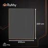 A dark background with a grid-patterned blanket and measurement indicators. Produktbild-Vorschau