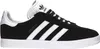 A side view of a black Adidas Gazelle sneaker with white stripes and sole. Produktbild-Vorschau