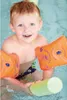 A young boy wearing armbands is in a swimming pool, holding a pool noodle. Produktbild-Vorschau