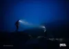 Two hikers with headlamps on a dark, misty mountain at night. Náhľad obrázku produktu