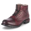 A single red leather boot with black laces and a white fur lining, presented against a white background. Produktbild-Vorschau