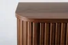 A close-up view of the top corner of a dark brown wooden cabinet with vertical fluting. Anteprima dell’immagine prodotto