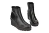A pair of black wedge ankle boots are displayed against a white background. Produktbild-Vorschau