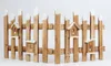 A wooden fence with small birdhouses attached, set against a white background. Náhled obrázku produktu