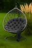 A hanging egg chair with a dark gray cushion and a dark gray throw blanket is placed on a green lawn next to tall, tan ornamental grasses. Produktbild-Vorschau